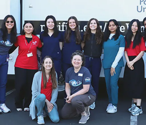 A group of 10 Pacific University College of Optometry students smile for the camera