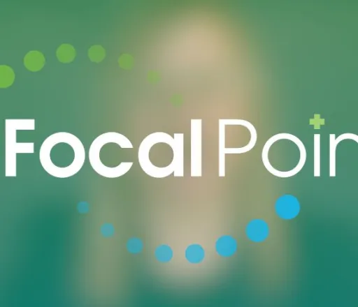 A blurred out, green screen capture from a video in the background with the Focal Point logo in white, green, and blue in the foreground